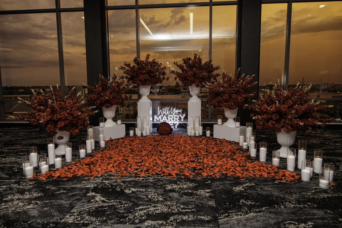 Wide terracotta floral proposal decor setup with candles
