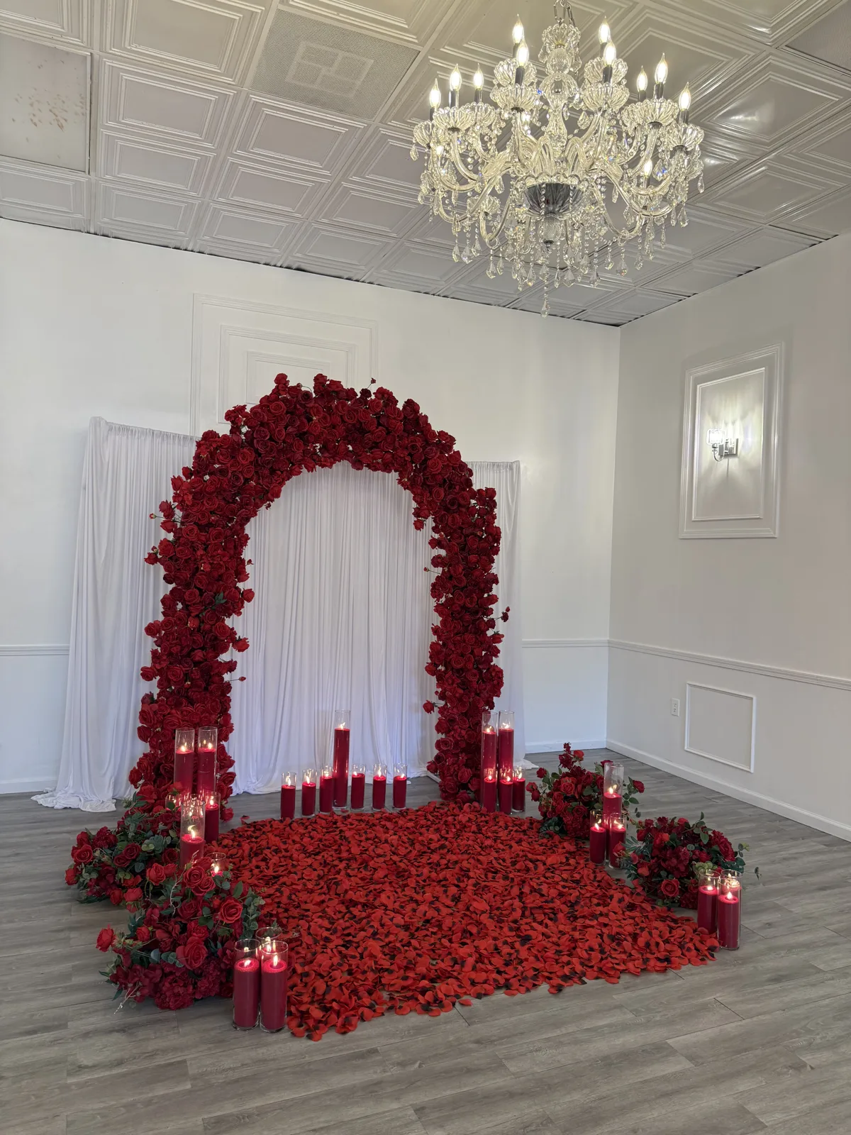Proposal venue Columbus Ohio — red rose arch and petal floor at Blanco Event Center